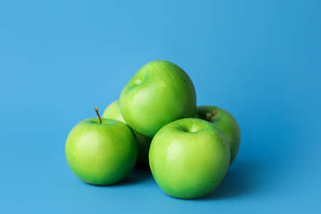 Fresh green apples on color backgroundの写真素材