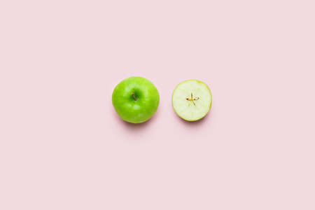 Fresh green apple with piece on color backgroundの写真素材