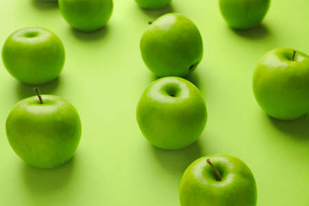 Fresh green apples on color backgroundの写真素材