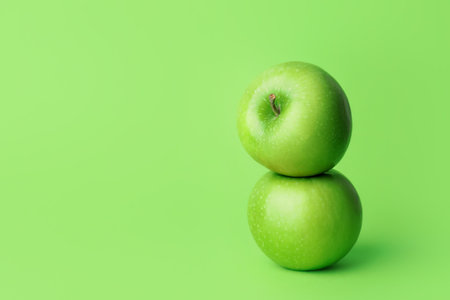 Fresh green apples on color backgroundの写真素材