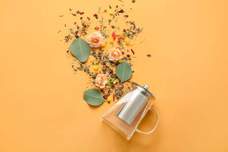 Composition with teapot, rose flowers and dry flowers on color background