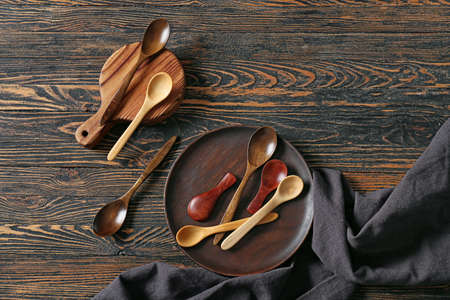 Spoons and plate on dark wooden backgroundの写真素材