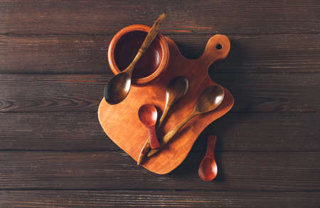 Spoons, bowl and board on dark wooden backgroundの写真素材