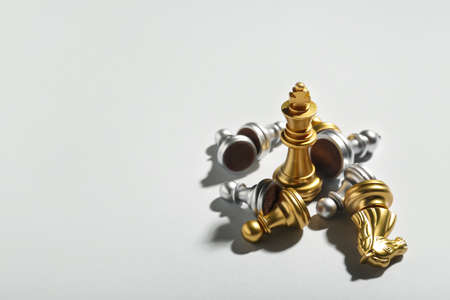 Chess pieces on gray background, closeup