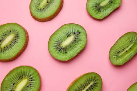 Slices of fresh kiwi fruit on color backgroundの写真素材