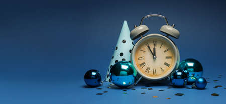Alarm clock with party hat and Christmas balls on blue background with space for textの写真素材