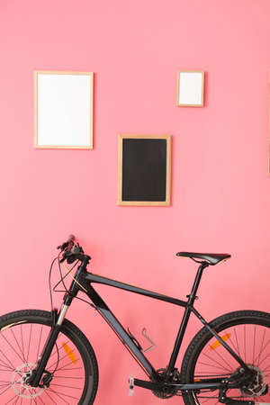 Modern bicycle near color wall