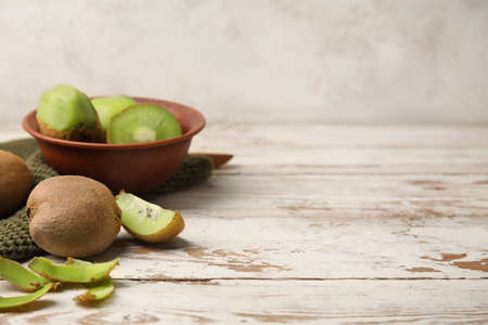Bowl with fresh kiwi fruit on tableの写真素材