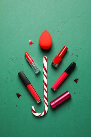 Christmas composition with makeup supplies on color backgroundの写真素材