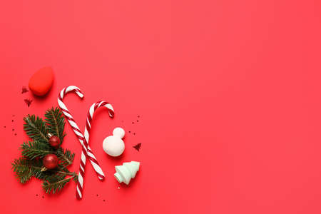 Christmas composition with makeup sponges on color background