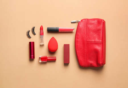 Bag with makeup supplies on color backgroundの写真素材