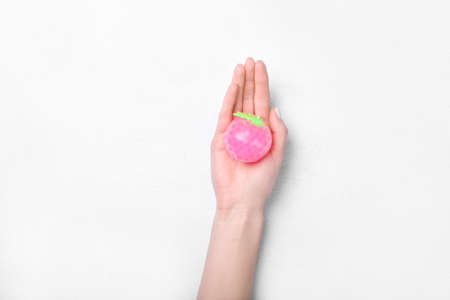 Female hand and stress ball on white backgroundの写真素材