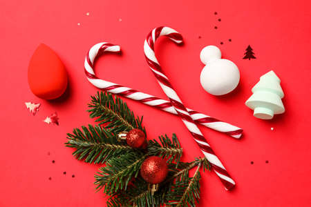 Christmas composition with makeup sponges on color backgroundの写真素材