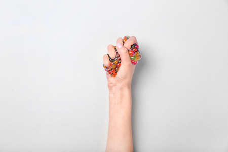 Female hand squeezing stress ball on white backgroundの写真素材
