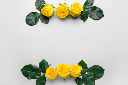 Composition with beautiful yellow roses on light backgroundの写真素材