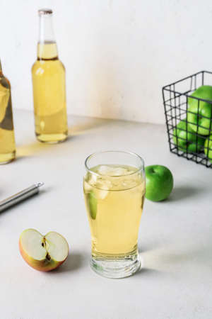 Glass of cold apple cider on tableの写真素材