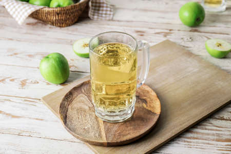 Board with mug of apple cider on tableの写真素材