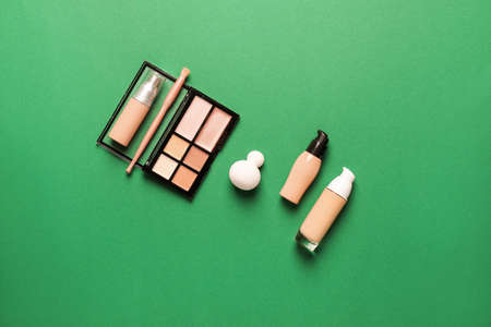 Makeup sponge with tonal foundation and blusher on color backgroundの写真素材