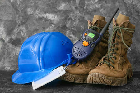 Portable radio transmitter, hardhat, boots and blank badge on dark backgroundの写真素材