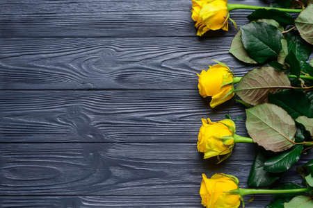 Beautiful yellow roses on wooden backgroundの写真素材