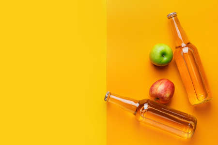 Composition with bottles of apple cider on color backgroundの写真素材