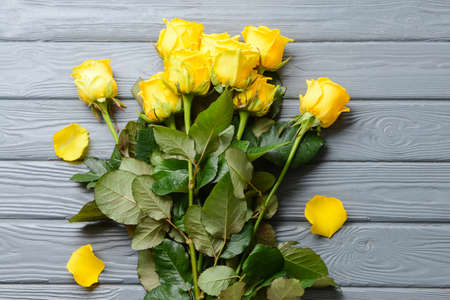 Beautiful yellow roses on wooden backgroundの写真素材
