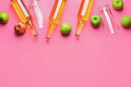 Composition with bottles of apple cider on color backgroundの写真素材