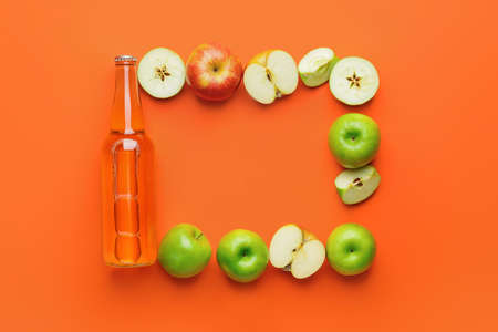 Composition with bottle of apple cider on color backgroundの写真素材