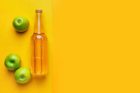 Composition with bottle of apple cider on color backgroundの写真素材