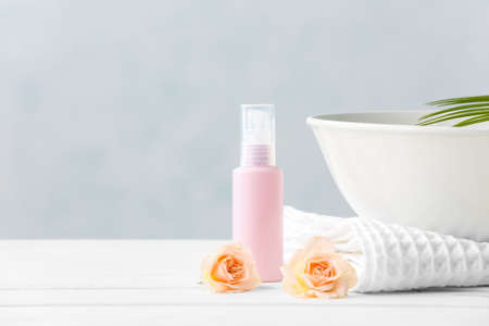 Spa set with bottle of cosmetic on light backgroundの写真素材