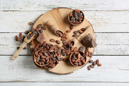 Composition with cocoa beans on white wooden backgroundの写真素材