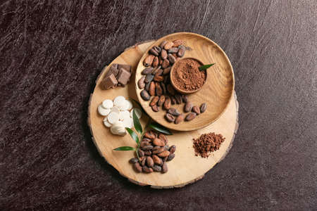 Composition with cocoa beans and chocolate on dark backgroundの写真素材