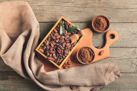 Composition with cocoa beans on wooden backgroundの写真素材