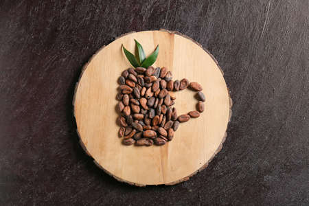 Cup shape made of cocoa beans on dark backgroundの写真素材