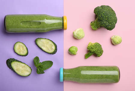 Composition with bottles of healthy green smoothie and ingredients on color background