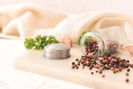 Jar with peppercorns on light backgroundの写真素材