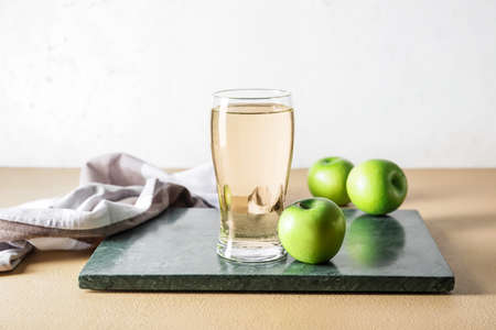 Glass of apple cider on tableの写真素材