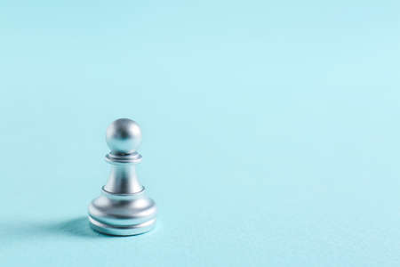 Silver pawn on color backgroundの写真素材