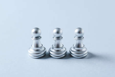 Silver pawns on light backgroundの写真素材