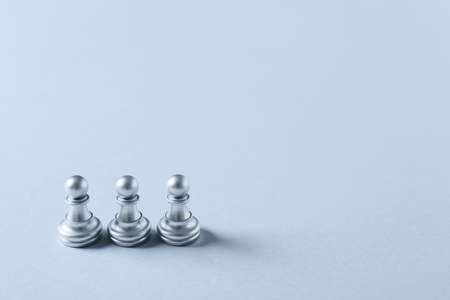Silver pawns on light backgroundの写真素材