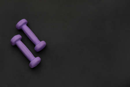 Purple dumbbells on dark backgroundの写真素材
