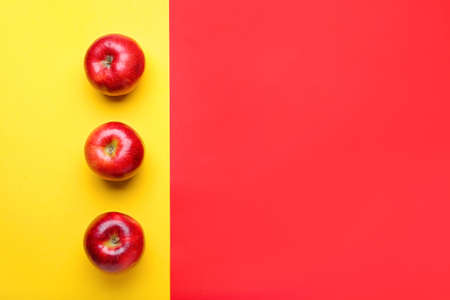 Fresh red apples on color backgroundの写真素材