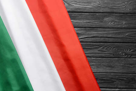 Italian flag on dark wooden background, closeupの写真素材