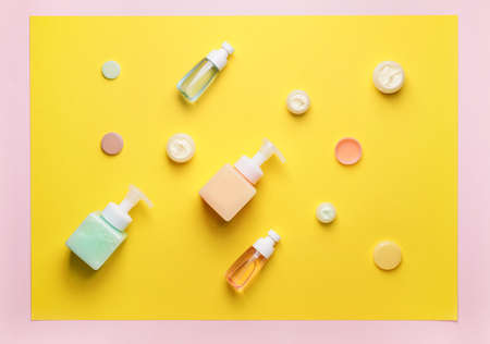 Bottles with different cosmetic products on color backgroundの写真素材