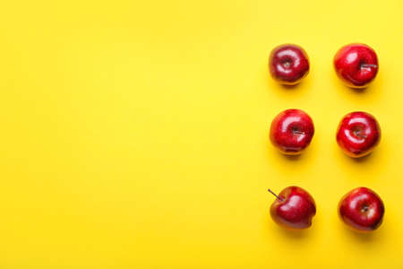Fresh red apples on color backgroundの写真素材