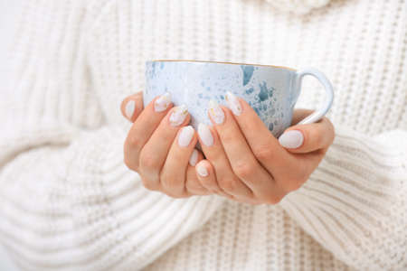 Young woman with beautiful manicure and cup of tea, closeupの写真素材