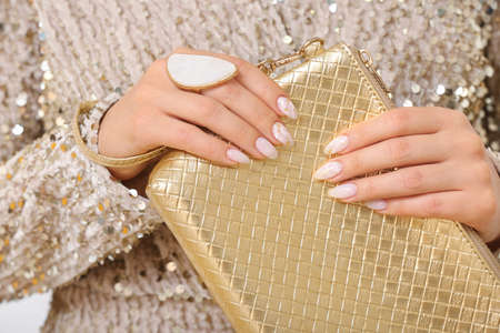 Young woman with beautiful manicure and bag, closeup