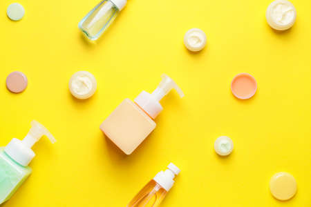 Bottles with different cosmetic products on color backgroundの写真素材