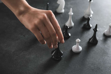 Woman playing chess on dark backgroundの写真素材