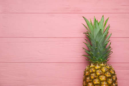 Fresh pineapple on color wooden backgroundの写真素材